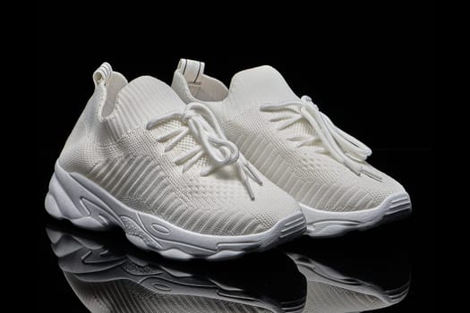 sneakers women's white summer breathable sneakers children's school uniform slip-ons for girls textile on black background. High quality photo