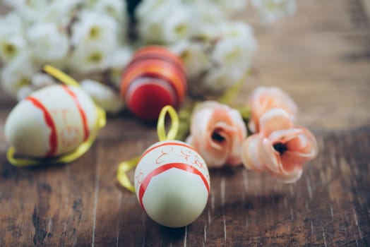 Easter egg and spring blossom flower closeup on rustic wooden table. Easter still life spring decoration.