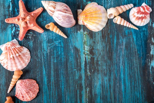 Seashell and star fish frame on rustic wooden texture background design with copyspace. Summer holiday and tropical beach travel concept.