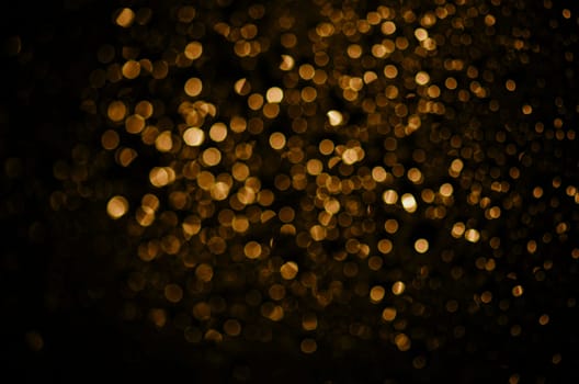 Blur neon gold light circle background. Sparkling firework bokeh dots in retro film filter style. Luxury and classy new year and christmas celebration party textured backdrop. Blurry golden dust particles.