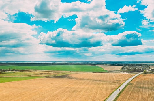 Aerial View. Sky With Clouds Above Countryside Rural Field And Road Landscape In Spring Cloudy Day. Scenic Sky With Fluffy Clouds On Horizon. Beauty In Nature.