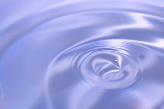 Beautiful blue background in the form of circles on the water. Universal abstract blurred background.