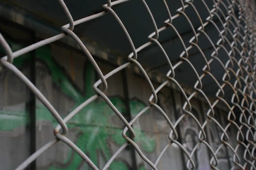 Rusty metal mesh close-up on the background of painted walls.