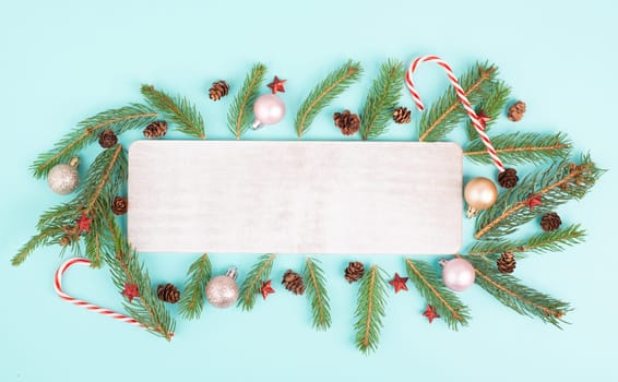 Christmas holiday background, frame with fir branches, baubles, candy cane and cones, winter season greeting card