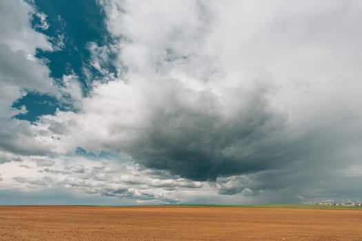 Countryside Rural Field Landscape With Empty Brown Soil. Early Spring Agricultural Season.