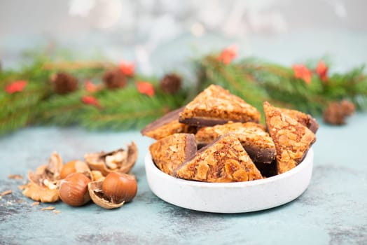 Nut corner triangles, traditional german sweets called Nussecke, covered with chocolate, christmas cake