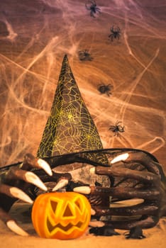 Halloween concept with witch hands, cobweb, spiders, rats and Jack o lantern ornament