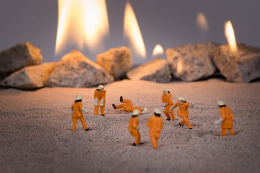Miniature people doing a safety fire drill and one of them fake falls