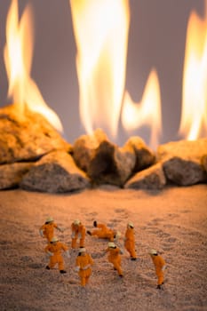 Miniature people doing a safety fire drill and one of them fake falls