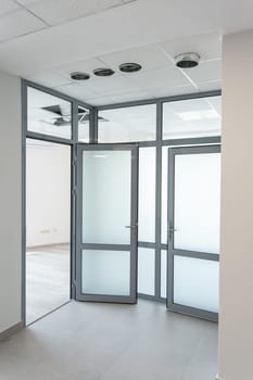 Empty office room with glass walls and doors. modern design for office. place to work. Concept of a new interior for the firm's office. Fresh workplace renovation