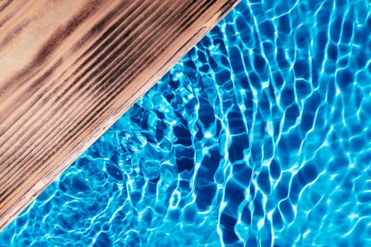 Wood platform table board in blue transparent reflect wave water surface ocean. Flat lay. Swimming pool. Healthy relaxation in sunny summer. Vacation spa coast sea, natural concept. Place for text