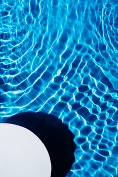 White quarter circle copy space in transparent fresh blue water gel surface. Flecks, waves, shade. Health care relaxation in summer beach. Vacation spa coast sea, natural concept. Flat lay. Vertical