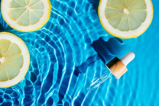 Facial pipette serum, whey beauty product near fruit citrus lemon in water splashing fresh transparent, flecks. Flat lay, top view. Summer beach tropical. Organic skin body antiage care in hot climate