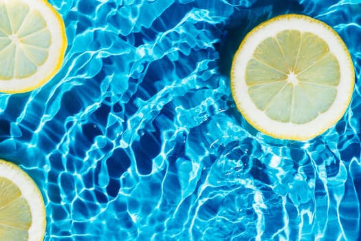 Transparent fresh exhilarant wave water with flecks background, lemon citrus slices. Summer freshness, healthy eating beach travel drinks concept. Vitaminic moisturizing care. Flat lay, copy space