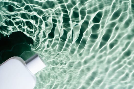 White square perfume bottle on green blue transparent reflect rippled wave water surface ocean. Fashion dermatology skin care. Right copy space. Place for text. Top view