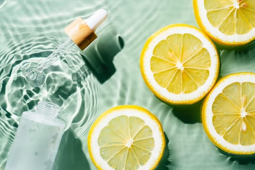 Facial pipette serum, whey beauty product near fruit citrus lemon in water splashing fresh transparent, flecks. Flat lay, top view. Summer beach tropical. Organic skin body antiage care in hot climate
