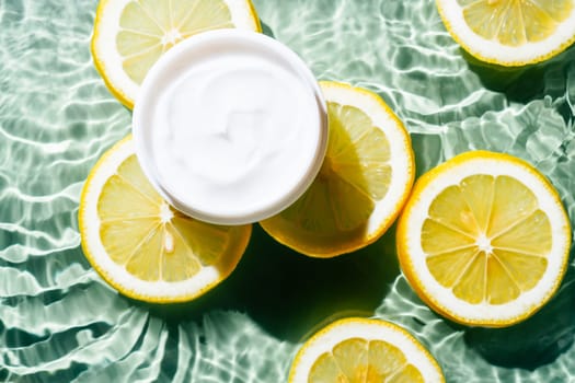 Facial jar cream milky beauty product with fruit citrus lemon slices in water splashing fresh transparent, flecks. Flat lay, top view. Summer beach tropical. Skin care in summer