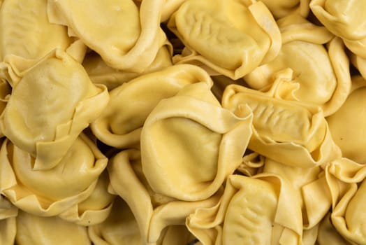 tasted italian food. Quantity of ravioli pasta as a background. Top view style