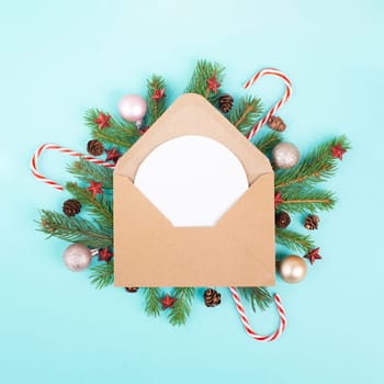 Christmas holiday background, enveloep with fir branches, baubles, candy cane and cones, winter season greeting card