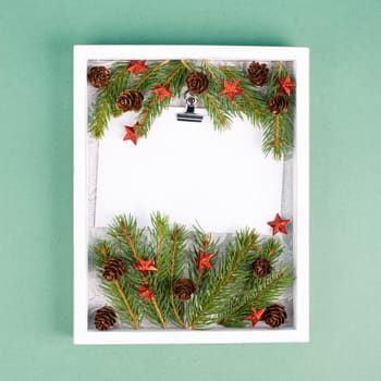 Christmas holiday background, frame with fir branches, stars, candy cane and pine cones, winter season greeting card