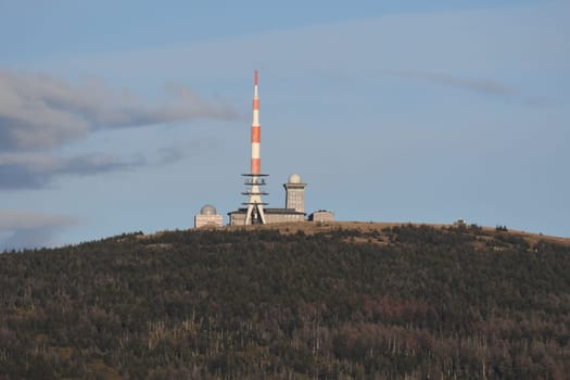 Radio tower and buildings on the Brocken mountain top under the blue sky in the Harz mountains