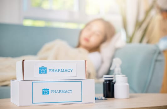 Asian young woman tired sick she sleep and resting on sofa after take medicines pills in living room at home, beautiful female use pharmacy first aid kit box delivery service from hospital, healthcare