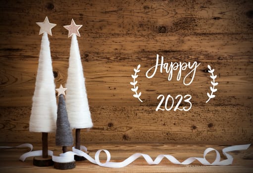 Christmas Decoration Like White Tree With Star On Wooden Background. White Ribbon For Festive Ornament. English Calligraphy Happy 2023