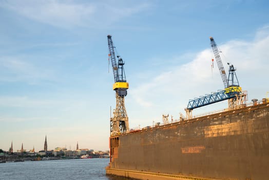 Hamburg view with dock and crane in front on the elbe