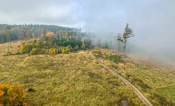 Aerial view of autumn sunrise countryside, traditional fall landscape with rising sun in Central Europe. Foggy and misty sunrise. Frozen landscape from bird eye. Czech Republic,Vysocina highland