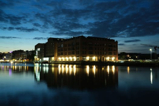 Old brick building illuminated at sunset in the harbor of Munster, Germany