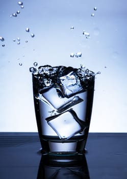 The image of pouring drinking water, into a glass, that makes one feel refreshed on blurred white background, Splashing water, Sparkling water