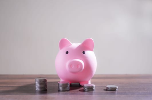 Save money and account banking for finance concept, Piggy bank with coin on blurred background, Save Monney for Investors Using Internet to Trade Stocks or Trade Fund