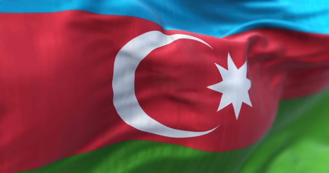Close-up view of the Azerbaijan national flag waving in the wind. Azerbaijan is a country located at the boundary of Europe and Asia. Fabric textured background. Selective focus
