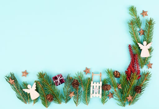 Christmas holiday background with fir branches, pine cones, angels and a sledge, winter season greeting card