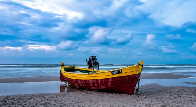 Sunset over Baltic Sea with fishing boat on the beach - Debki, Pomerania, Poland
