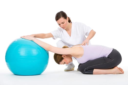 woman with physiotherapist exercising and reinforcing the vertebral column