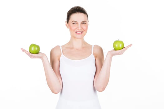 young woman holding two .apples and looking at camera.