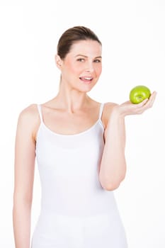 young woman holding an apple and looking at camera.