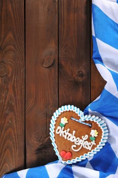 original Bavarian gingerbread heart with Bavarian flag on old weathered wooden boards