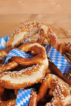original Bavarian lye pretzels with salt in a basket on wooden boards