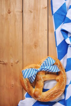 original Bavarian giant folk festival breze with Bavarian flag on wooden boards