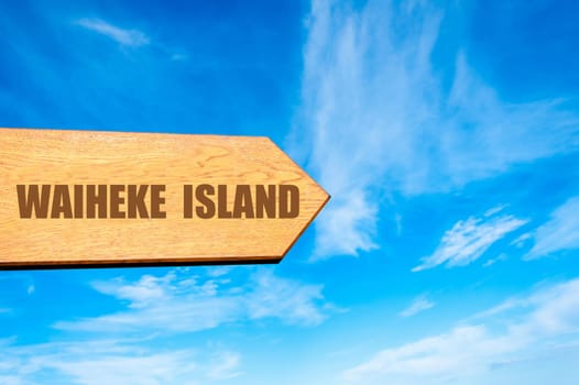 Wooden arrow sign pointing destination WAIHEKE ISLAND, NEW ZEALAND against clear blue sky with copy space available. Travel destination concept  image