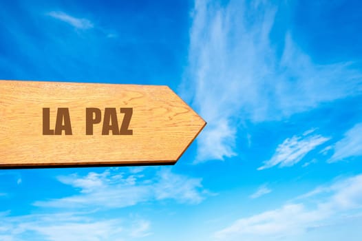 Wooden arrow sign pointing destination LA PAZ, BOLIVIA against clear blue sky with copy space available. Travel destination concept  image