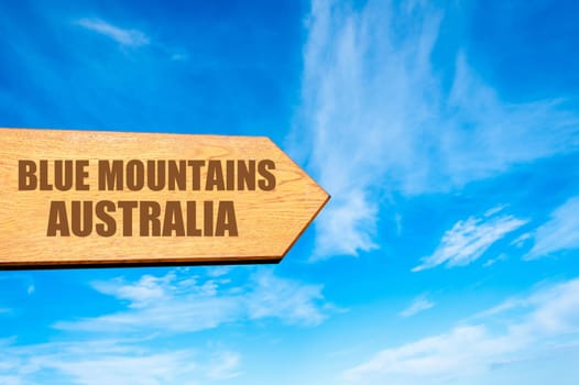 Wooden arrow sign pointing destination BLUE MOUNTAINS, AUSTRALIA  against clear blue sky with copy space available. Travel destination concept  image