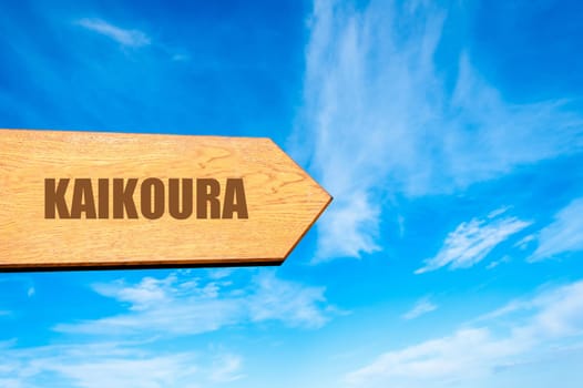 Wooden arrow sign pointing destination KAIKOURA, NEW ZEALAND  against clear blue sky with copy space available. Travel destination concept  image
