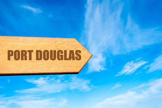 Wooden arrow sign pointing destination PORT DOUGLAS, AUSTRALIA  against clear blue sky with copy space available. Travel destination concept  image