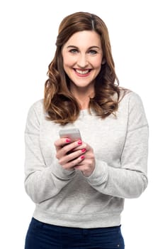 Smiling woman texting from her cellphone