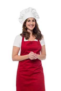 Female chef posing with hands clasped