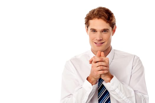 Smart young male executive with hands clasped