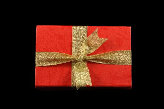 Gift box with golden ribbon isolated over black